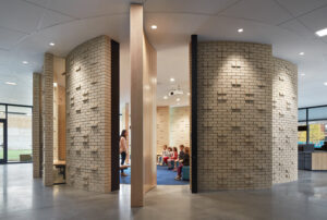 Interior circular brick wall with openings and projecting brick on the Bernard Zelle Day School