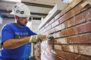 BAC craftworking performing a brick replacement in restoration training
