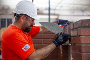 BAC member installing soldier brick course