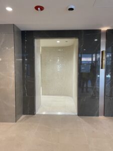 Marble and tile entrance to the men's bathroom and locker rooms at One Lifetime Fitness