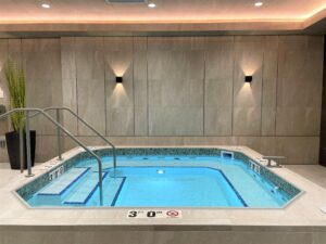 Mosaic tile feature wall and tiled benches and floors inside a sauna at One Lifetime Fitness