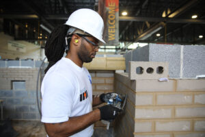 PCC apprentice tools mortar joints on mockup in training center